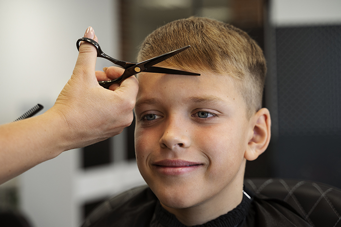 smiley-kid-getting-haircut-salon-side-view