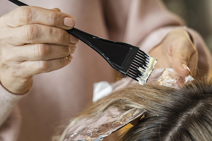 woman-getting-her-hair-dyed-home-by-beautician